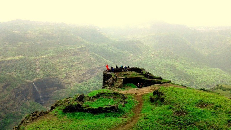 Rajmachi Fort trek in Maharashtra with lush green valleys and waterfalls during monsoon